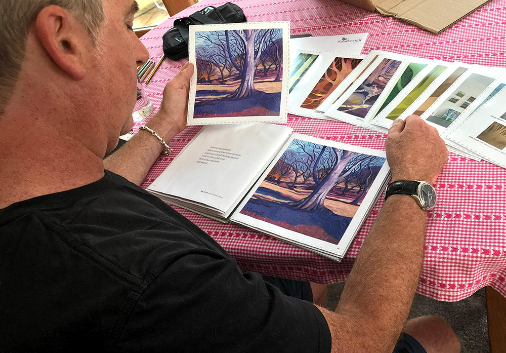 Chris Cyprus Artist ~ creating his dream trees book as he looks at the pre-printed version on his kitchen table at home