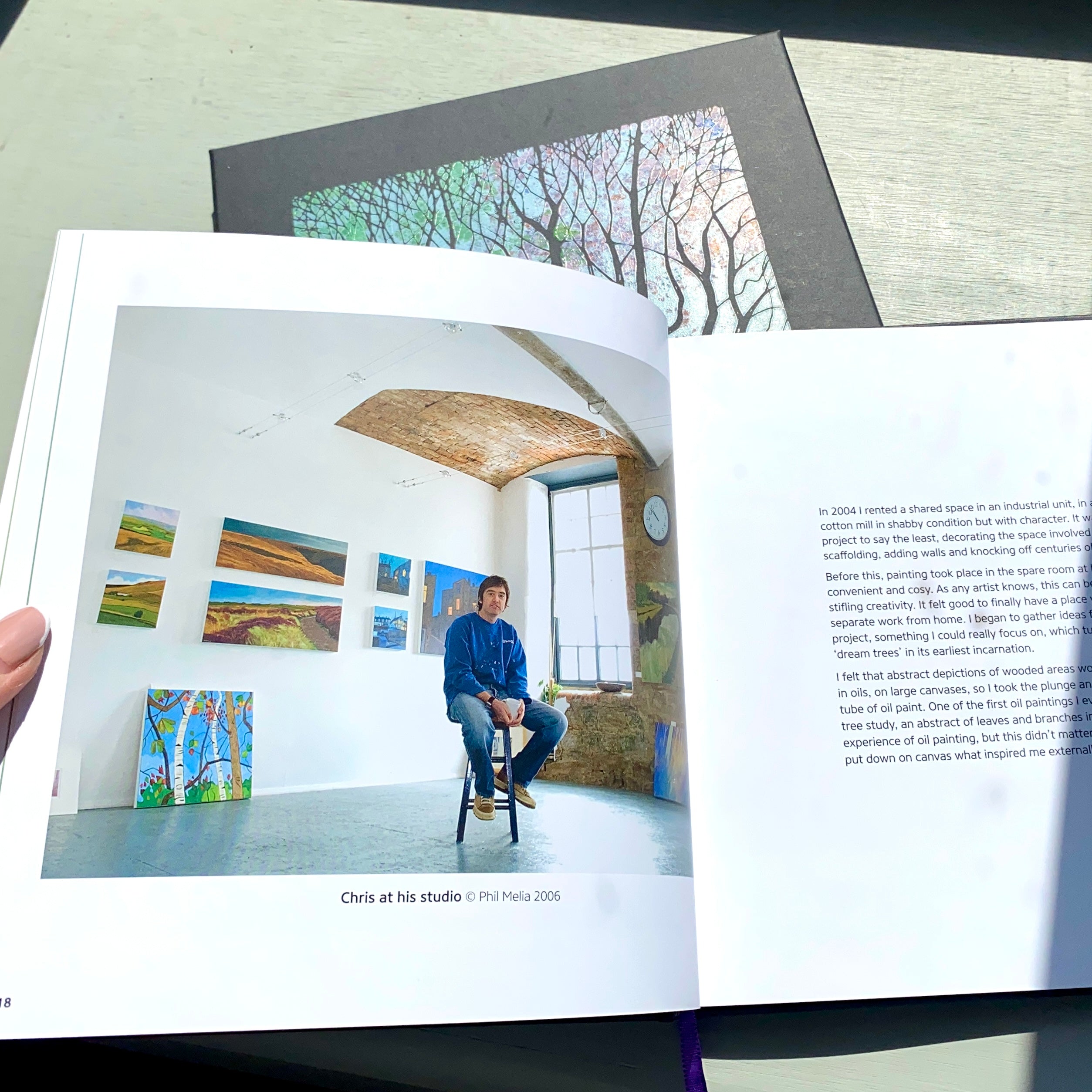 'Dream Trees' Book by artist Chris Cyprus. Showing the book open at the page with a portrait of Chris at his studio in 2006.  