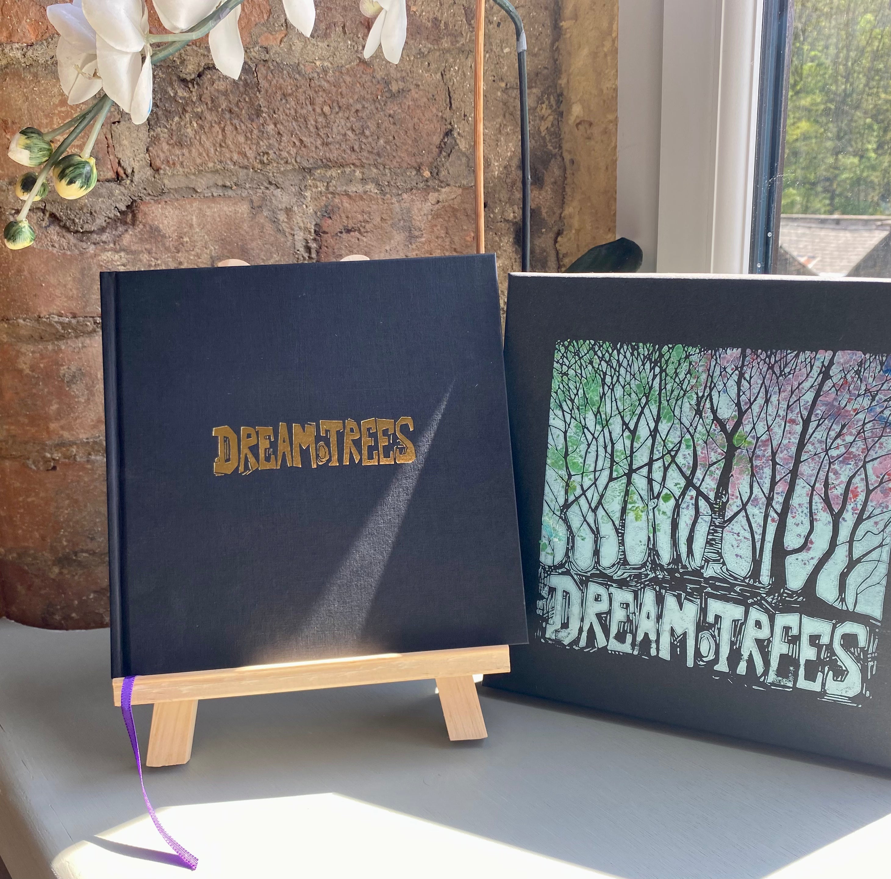 Dream Trees hardback Book by Chris Cyprus Artist. Boxed Edition with hand printed Lino-Cut  logo on the box Lid. Gold inlay dream trees logo on the book cover.
